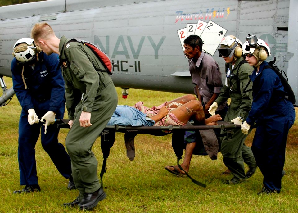 US Navy 050106-N-4166B-275 Sailors assigned to Carrier Air Wing Two (CVW-2) and USS Abraham Lincoln (CVN 72), carry an injured Indonesian woman from an MH-60S Knighthawk helicopter