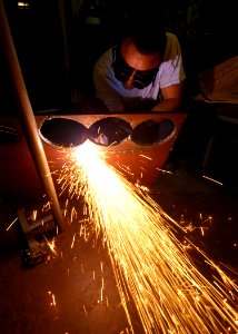 US Navy 050128-N-8704K-002 A Sailor cuts out a steel plate for replacement in a fire station aboard the conventionally powered aircraft carrier USS John F. Kennedy (CV 67)