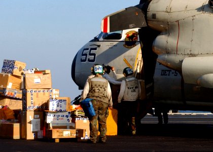 US Navy 050113-N-6363M-033 Sailors assigned to Carrier Airborne Early Warning Squadron One Two Six (VAW-126), help unload mail from a C-2A Greyhound