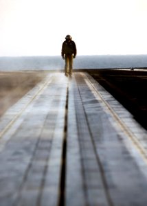 US Navy 050113-N-6363M-024 A Sailor assigned to the Air Department aboard USS Harry S. Truman (CVN 75) inspects one of the four steam-powered catapults prior to the commencement of flight operations