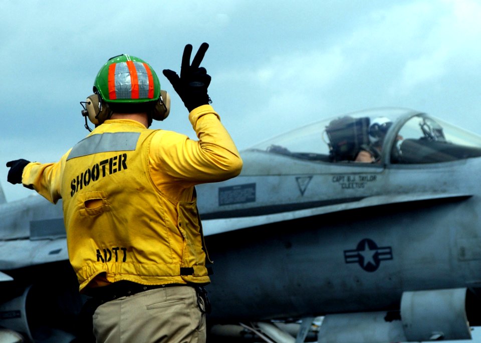 US Navy 041209-N-6363M-006 Lt. cmdr. Brian Weiss prepares to launch an F-A-18A- Hornet assigned to the Silver Eagles of Marine Fighter Attack Squadron One One Five (VMFA-115)