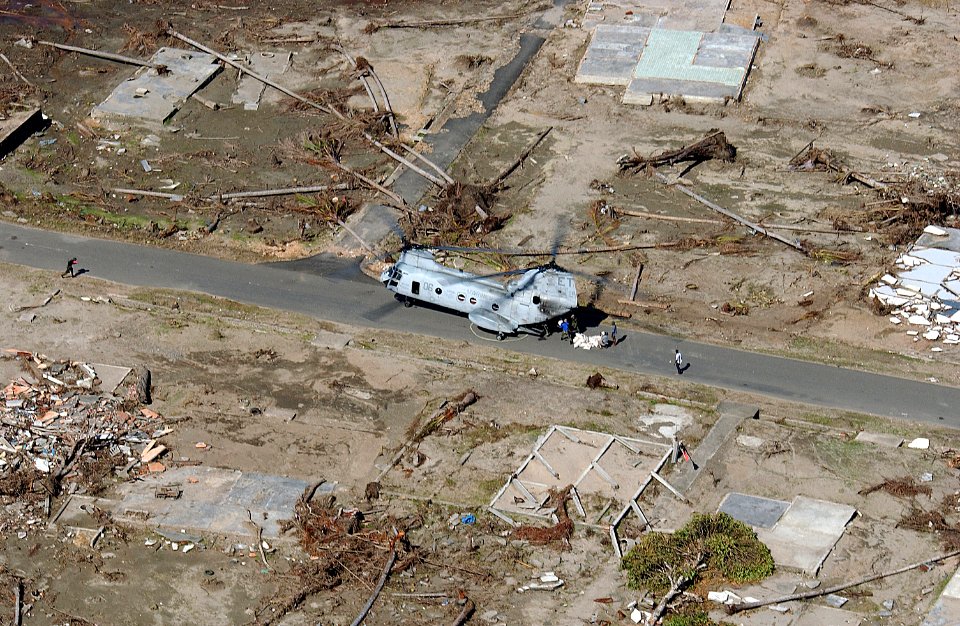 US Navy 050116-F-4884R-026 Air crew aboard a Marine Corps CH-46E Sea Knight helicopter unload humanitarian aid and disaster relief supplies in a remote region on the island of Sumatra, Indonesia