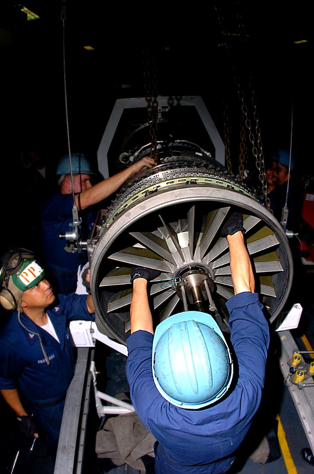 US Navy 050203-N-9273C-011 Sailors, assigned to IM-2 Division, Aviation Intermediate Maintenance Department (AIMD), install a fan module onto a F414 jet engine