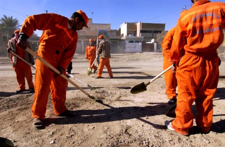 US Navy 041213-N-4614W-029 Twenty-two Iraqi contracted nationals, working with brooms and shovels, clear nearly three blocks of broken walls, glass and trash along a major thoroughfare in the city of Fallujah, Iraq