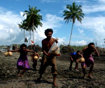 US Navy 050119-N-2653P-525 Survivors of the Dec 26th Tsunami rush to an U.S. Navy helicopter as they drop off humanitarian relief on the island of Sumatra, Indonesia photo