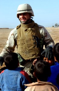 US Navy 050124-N-1810F-457 Ens. Majid Awad from Bahrain, plays with local Iraqi children
