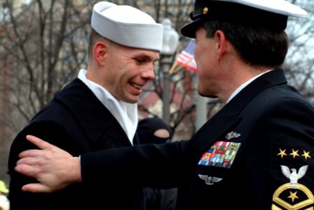 US Navy 050120-N-0962S-063 Master Chief Petty Officer of the Navy (MCPON) Terry Scott gives a congratulatory pat on the shoulder to one of the hundreds of Sailors who helped line the street cordon down Pennsylvania Avenue for t