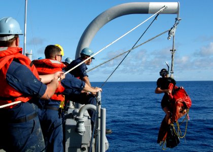 US Navy 050124-N-3019M-004 Sailors lift Search and Rescue Swimmer Hospital Corpsman 3rd Class Amber Bouge and Oscar out of the water during a man overboard drill aboard the Safeguard-class rescue and salvage ship USS Salvor (AR