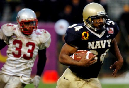 US Navy 041230-N-9693M-378 U.S. Naval Academy slot back Eric Roberts outpaces New Mexico linebacker Fola Fashola for yardage in the 4th quarter of play against the Lobos of New Mexico