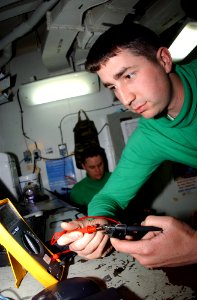 US Navy 050208-N-7267C-002 Aviation Electricians Mate Airman Joshua Wear, assigned to the Black Knights of Strike Fighter Squadron One Five Four (VFA-154), safety checks electrical equipment to make sure it is safe for shipboa