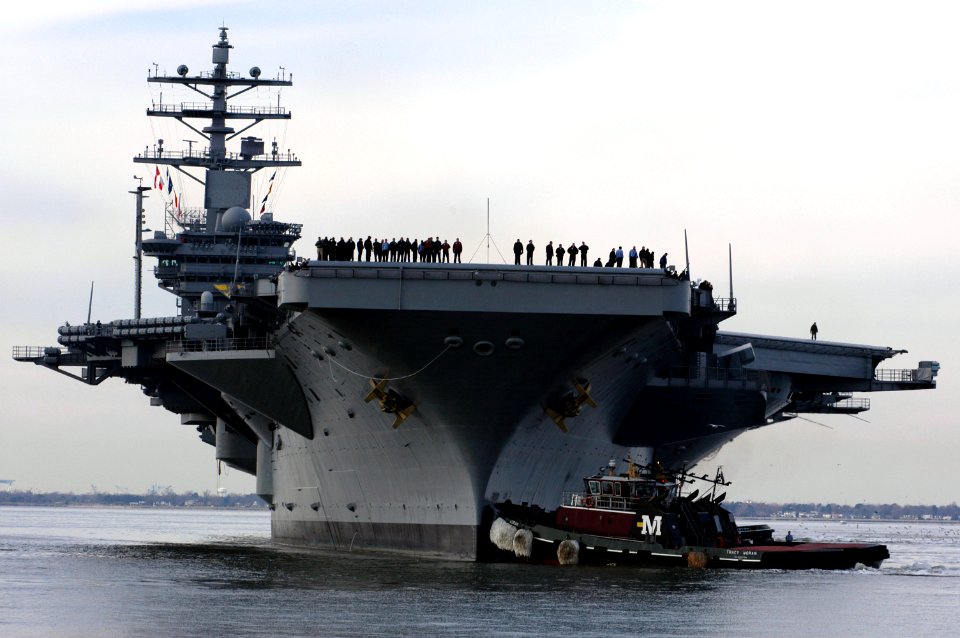 US Navy 050125-N-9600H-123 Sailors watch from the flight deck of USS Dwight D. Eisenhower (CVN 69) during her arrival at Naval Station Norfolk, Va