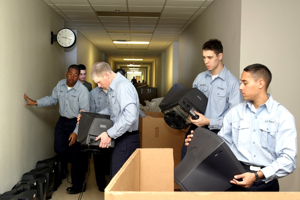 US Navy 050126-N-4204E-006 New Students unpack tri-walls of computers at Chevalier Hall on board Naval Air Station Pensacola, Fla