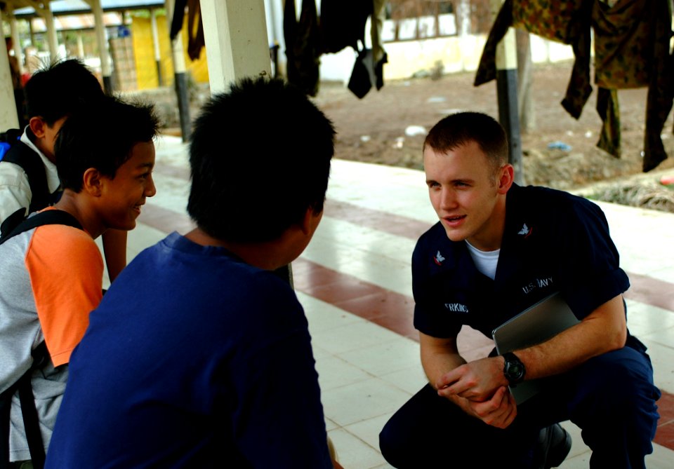 US Navy 050212-N-0357S-130 Hospital Corpsman 3rd Class Benjamin Perkins talks with Indonesian children at Albadin University Hospital in Banda Aceh, Sumatra, Indonesia