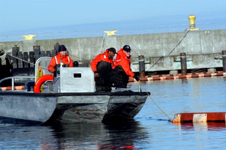 US Navy 050215-N-3390M-318 Boatswain's Mate 2nd Class Pete Johnson, Boatswain's Mate 2nd Class Sorrells Claiborne and Engineman 3rd Class Johnny Thresh, assigned to Port Operations on board Naval Station Everett photo