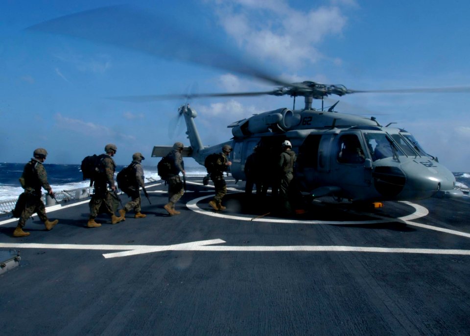 US Navy 050103-N-9079D-376 Marines assigned to the 3rd Fleet Antiterrorism Security Team (FAST) load into an MH-60S Knighthawk helicopter