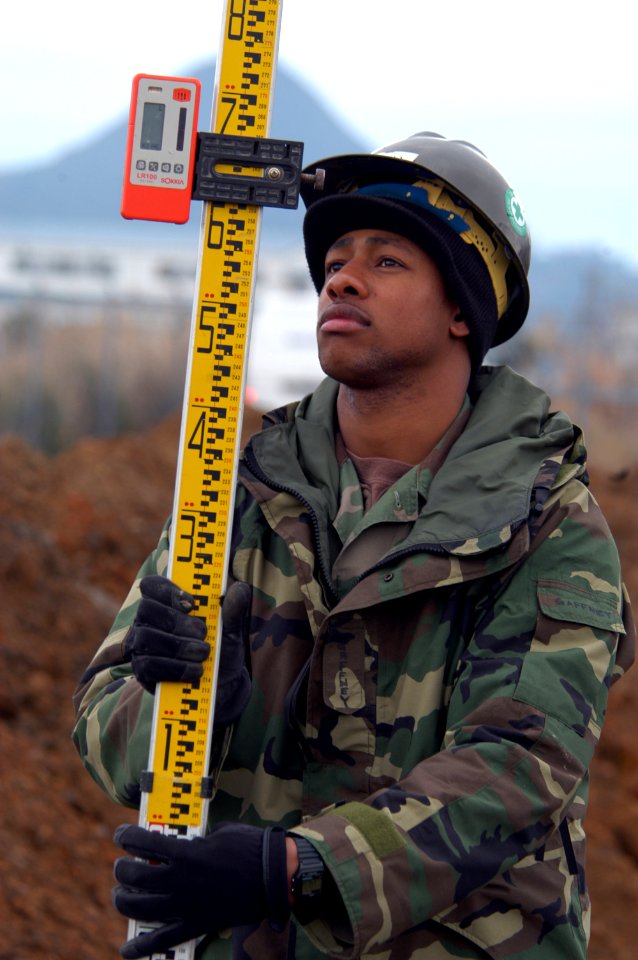 US Navy 050215-N-2385R-023 Engineering Aide Constructionman Doug Gaffney, assigned to Naval Mobile Construction Battalion Four Zero (NMCB-40), Detachment Sasebo, uses a Philadelphia Rod to adjust for elevation