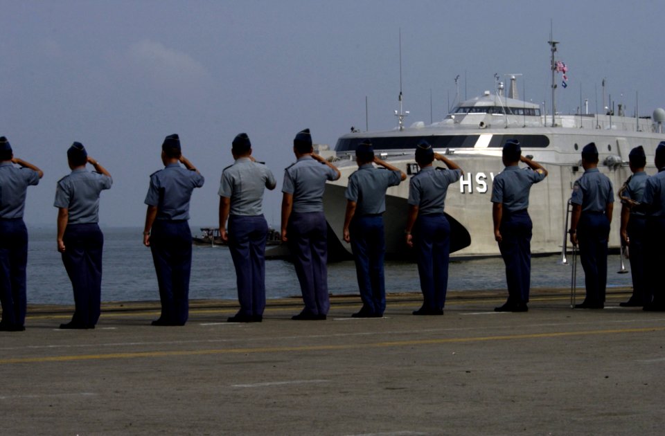 US Navy 050203-N-3642E-009 Indonesian military personnel render a salute to the High Speed Vessel Two (HSV-2) Swift as it prepares to be moored at the pier in Belawan, Indonesia