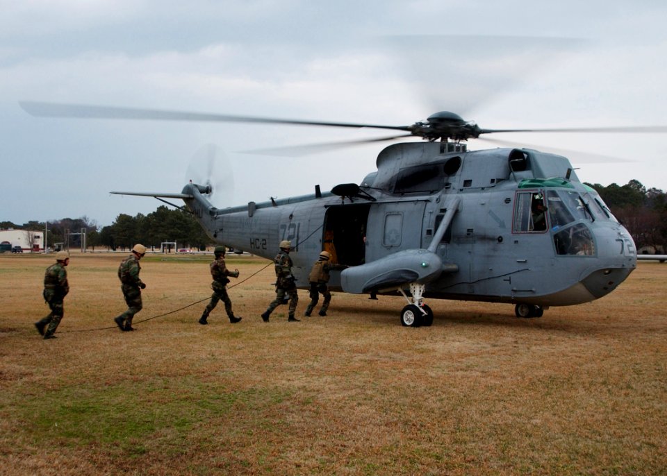 US Navy 050216-N-4374S-004 Sailors assigned to Explosive Ordnance Disposal Mobile Unit Two (EODMU-2), board a UH-3H Sea King helicopter
