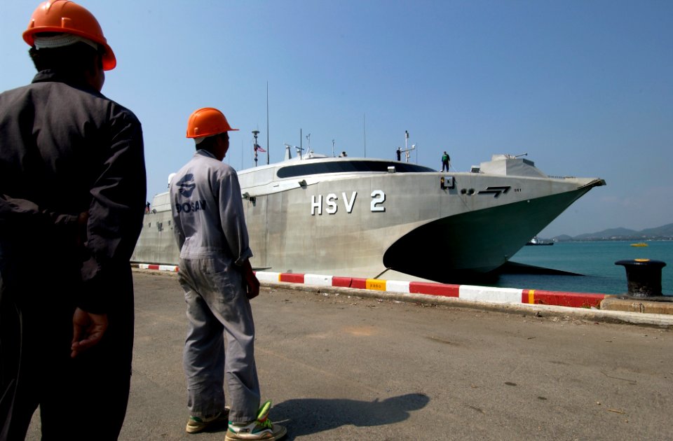 US Navy 050207-N-3642E-003 Dock workers stand ready to moor the High Speed Vessel Two (HSV-2) Swift as she prepares to dock at the Chuc Sumet Port in Sattahip, Thailand