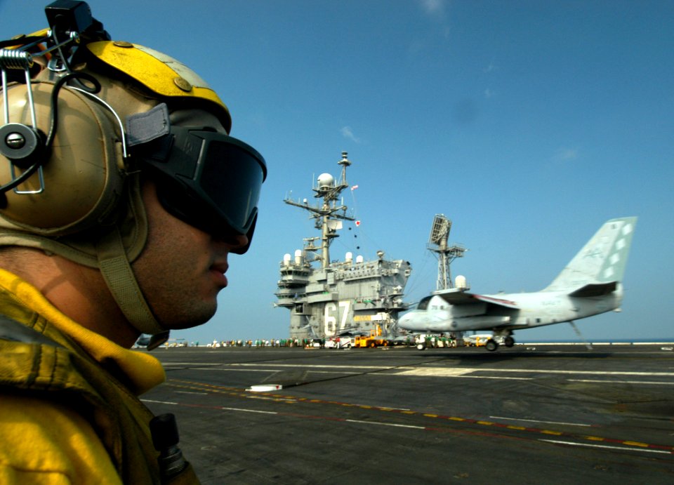 US Navy 050217-N-8704K-001 Aviation Boatswain Mate 3rd Class Danny Espana looks-on as an S-3B Viking makes an arrested landing aboard the conventionally powered aircraft carrier USS John F. Kennedy (CV 67)