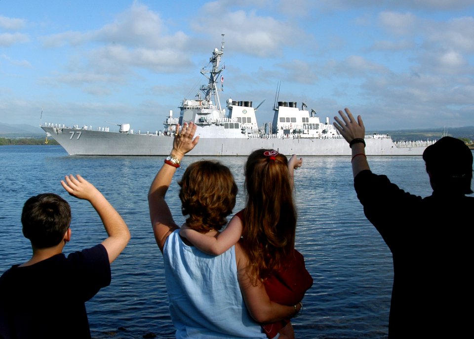 US Navy 050207-N-3019M-006 Family members wave goodbye to their loved ones aboard the Arleigh Burke-class guided missile destroyer USS O'Kane (DDG 77) as she leaves Pearl Harbor, Hawaii for a scheduled deployment