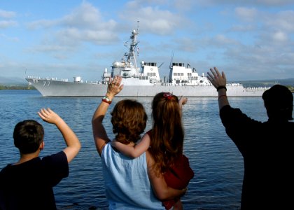 US Navy 050207-N-3019M-006 Family members wave goodbye to their loved ones aboard the Arleigh Burke-class guided missile destroyer USS O'Kane (DDG 77) as she leaves Pearl Harbor, Hawaii for a scheduled deployment