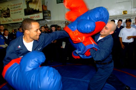 US Navy 050226-N-9866B-004 Two Sailors aboard the amphibious assault ship USS Peleliu (LHA 5) swing at each other in a boxing match on the ship's flight deck during a Steel Beach Picnic