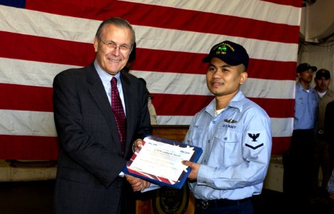 US Navy 050209-F-7203T-203 Secretary of Defense (SECDEF) Donald H. Rumsfeld presents an award to Culinary Specialist Seaman Sameth Moth during an awards ceremony aboard the Spruance-class destroyer USS O'Bannon (DD 987) in Nice