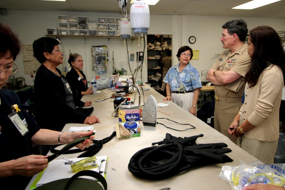 US Navy 050225-N-3228G-010 Master Chief Petty Officer of the Navy (MCPON) Terry Scott receives feedback from tailors at the Navy Exchange Uniform Shop