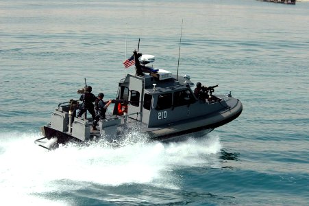US Navy 050303-N-0000X-003 Sailors assigned to Inshore Boat Unit Two Four (IBU-24) conduct a security patrol in the waters near Kuwait Naval Base photo