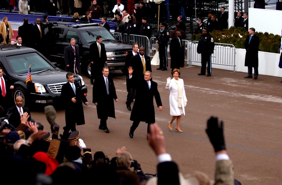 US Navy 050120-F-3231D-551 President George W. Bush and First Lady Laura Bush wave to the crowd as they walk down the Presidential Inaugural Parade route in Washington D.C