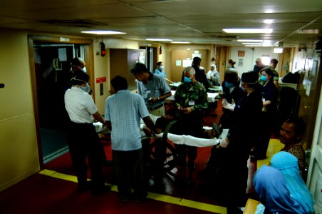 US Navy 050211-N-0357S-042 U.S. Navy Hospital Corpsmen, assigned to Navy Environmental and Preventive Medicine Unit Six (NEPMU-6), and an Indonesian interpreter, assess patients evacuated from Banda Ache, Sumatra Indonesia,