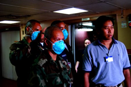 US Navy 050211-N-0357S-040 U.S. Navy Hospital Corpsmen, assigned to Navy Environmental and Preventive Medicine Unit Six (NEPMU-6), and an Indonesian interpreter, await the arrival of patients from Banda Ache, Sumatra Indonesia