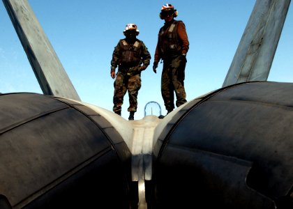 US Navy 050212-N-6363M-046 U.S. Marine Corps Cpl. Lee Sanders, left, and Lance Cpl. Michael Miller inspect an F-A-18A- Hornet prior to the commencement of flight operations aboard USS Harry S. Truman (CVN 75)