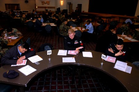 US Navy 050120-N-2385R-005 First Class Petty Officers check their answer sheets prior to beginning the Chief Petty Officer Exam held at the Harbor View Club on board U.S. Fleet Activities Sasebo, Japan