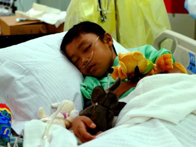 US Navy 050214-N-0357S-060 An 11-year old Indonesian boy rests in a hospital bed in the Intensive Care Unit aboard the Military Sealift Command (MSC) hospital ship USNS Mercy (T-AH 19) photo