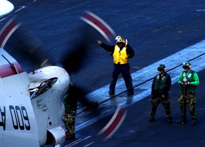 US Navy 050214-N-6363M-012 Sailors position an E-2C Hawkeye, assigned to the Seahawks of Carrier Airborne Early Warning Squadron One Two Six (VAW-126), for launch aboard the Nimitz-class aircraft carrier USS Harry S. Truman (CV