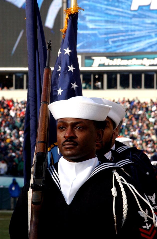 US Navy 050123-N-4729H-029 Aviation Ordnanceman 2nd Class Rudoff Liverpool, assigned to Navy Recruiting District Philadelphia, stands by to parade the colors before the National Football League National Football Conference cham
