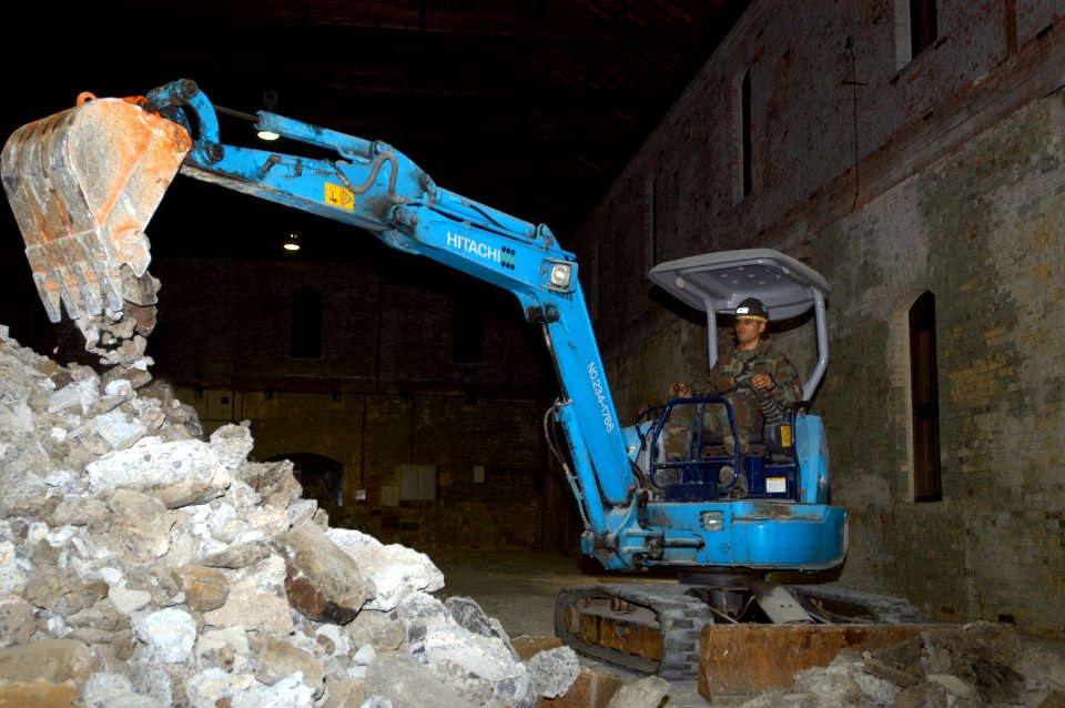 US Navy 050215-N-2385R-095 Crew Leader, Equipment Operator 2nd Class Nefthali Perez, assigned to Naval Mobile Construction Battalion Four Zero (NMCB-40), Detachment Sasebo, removes debris and concrete