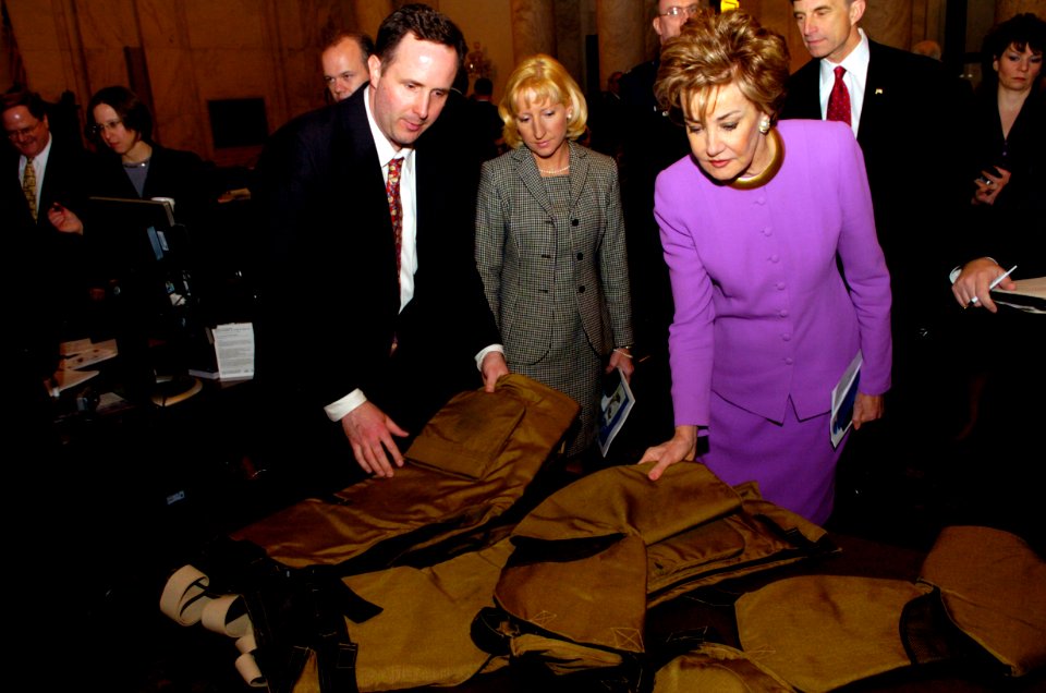 US Navy 050309-N-7676W-010 Tim Henkle explains a new flexible arm and leg protective armor for Soldiers and Marines to Senator Elizabeth Dole, (R-NC)