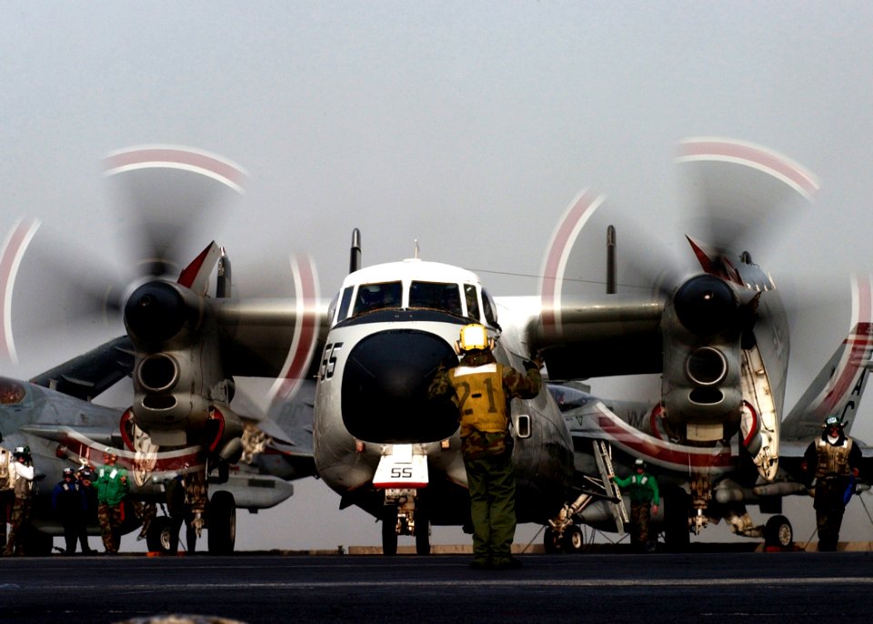 US Navy 050125-N-6363M-016 Aviation Boatswain's Mate Handler 3rd Class Darnell Dobbs directs the movement of a C-2 Greyhound assigned to the Rawhides of Fleet Logistics Support Squadron Four Zero (VRC-40)