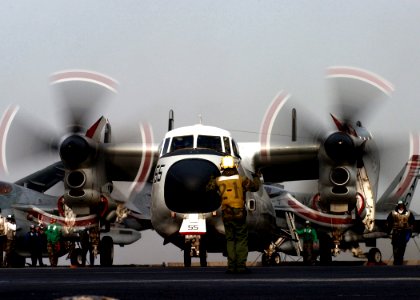 US Navy 050125-N-6363M-016 Aviation Boatswain's Mate Handler 3rd Class Darnell Dobbs directs the movement of a C-2 Greyhound assigned to the Rawhides of Fleet Logistics Support Squadron Four Zero (VRC-40)