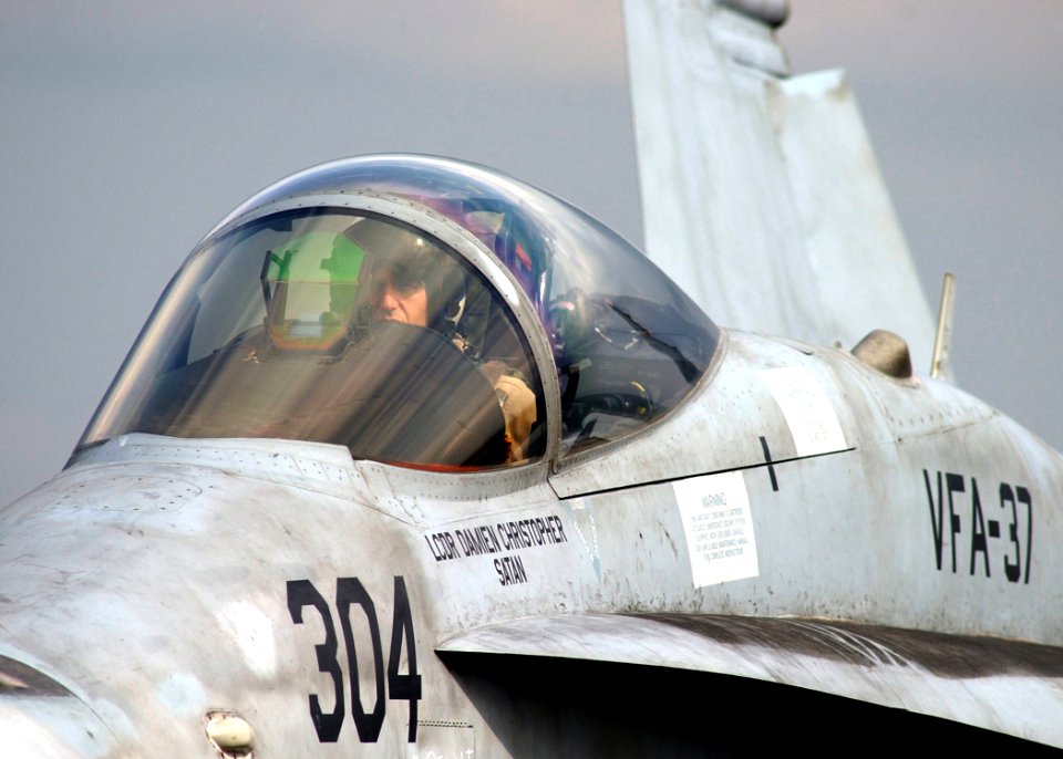 US Navy 050209-N-6363M-012 A Naval Aviator, assigned to the Bulls of Strike Fighter Squadron Three Seven (VFA-37), performs preflight checks on the flight deck aboard the Nimitz-class aircraft carrier USS Harry S. Truman (CVN 7