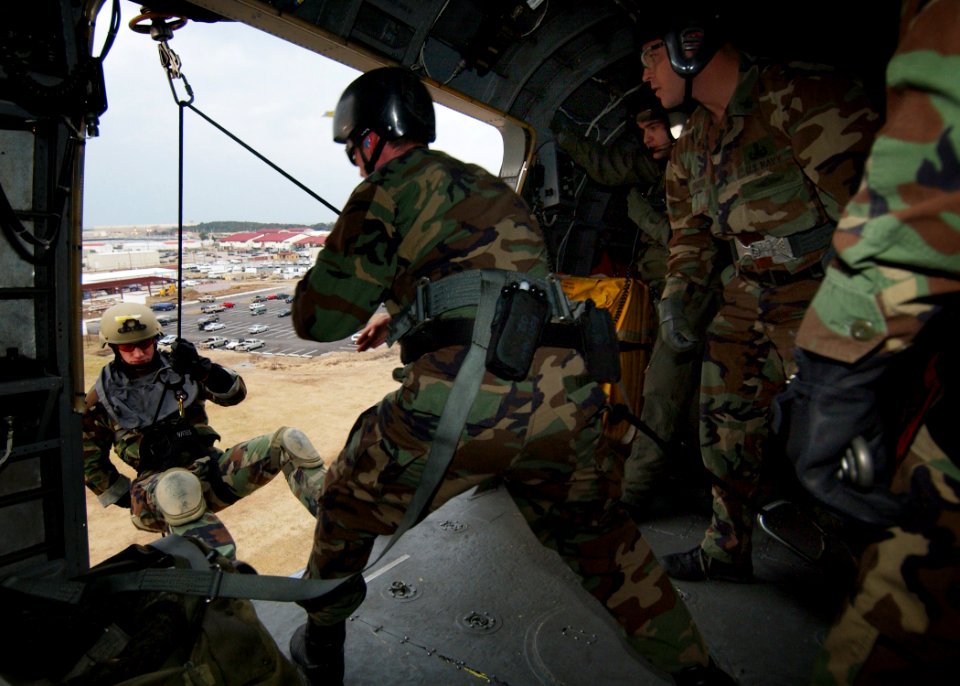 US Navy 050216-N-4374S-003 A Sailor assigned to Explosive Ordnance Disposal Mobile Unit Two (EODMU-2), rappels out of a UH-3H Sea King helicopter