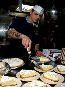 US Navy 050217-N-3390M-015 Quartermaster 3rd Class Derek Declue prepares lemon pie to be served aboard the guided missile frigate USS Rodney M. Davis (FFG 60)
