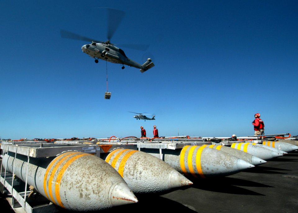 US Navy 050313-N-8704K-004 An SH-60F Seahawk helicopter lifts a pallet of ordnance from the flight deck aboard USS John F. Kennedy (CV 67) during an ammunitions and ordnance off-load