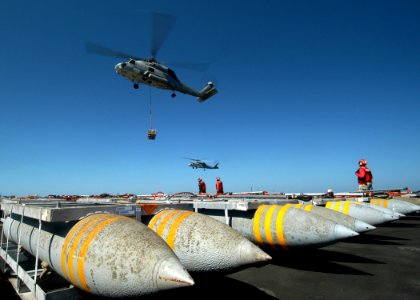 US Navy 050313-N-8704K-004 An SH-60F Seahawk helicopter lifts a pallet of ordnance from the flight deck aboard USS John F. Kennedy (CV 67) during an ammunitions and ordnance off-load