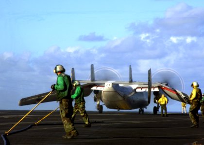 US Navy 050225-N-3241H-050 Air Department personnel guide an arresting cable after the successful recovery of a C-2A Greyhound