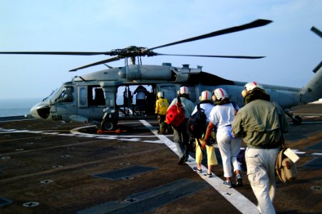US Navy 050224-N-0357S-104 Volunteer healthcare workers from the non-governmental organization Project Hope board a MH-60S Seahawk helicopter, assigned to Helicopter Combat Support Squadron Five (HC-5)
