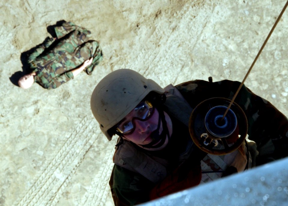 US Navy 050304-N-4374S-005 A member of Explosive Ordnance Disposal Mobile Unit Six (EODMU-6) is hoisted down to perform a Combat Search and Rescue (CSAR) exercise from a UH-3H Sea King helicopter